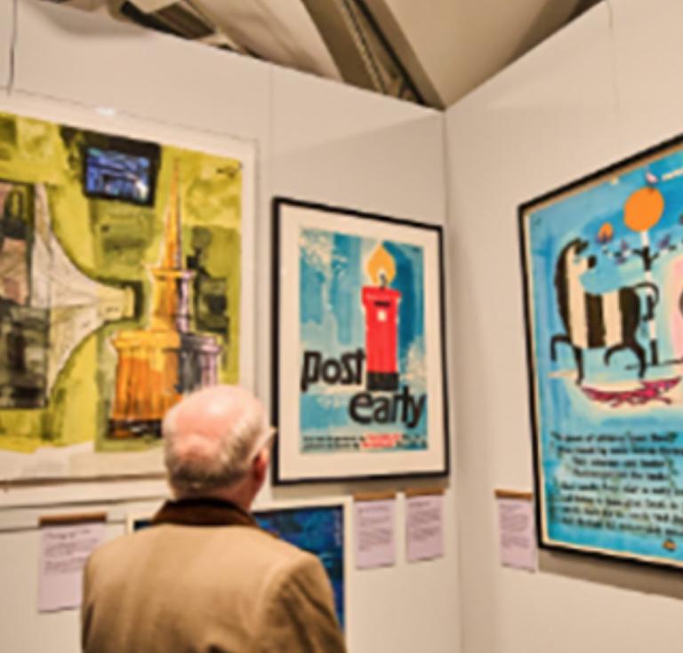 A visitor viewing the new How to Make a Poster exhibition